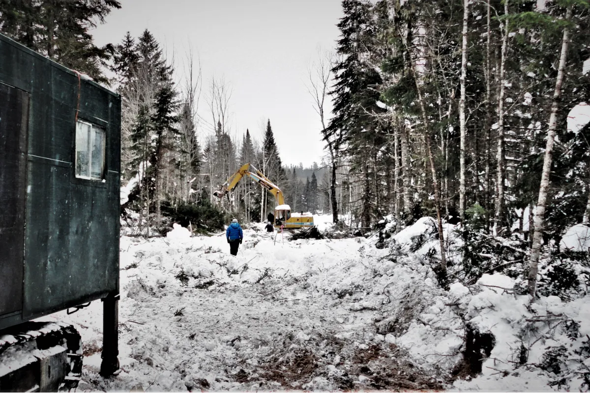 Canadian Copper mine in winter, forest with snow and shack.
